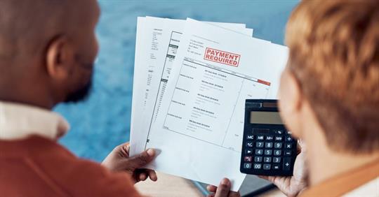 Couple facing various bills and debt